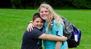 camper hugging counselor