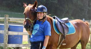 adult woman with horse at camp