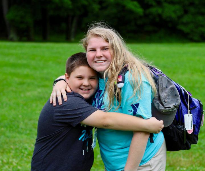 camper hugging counselor