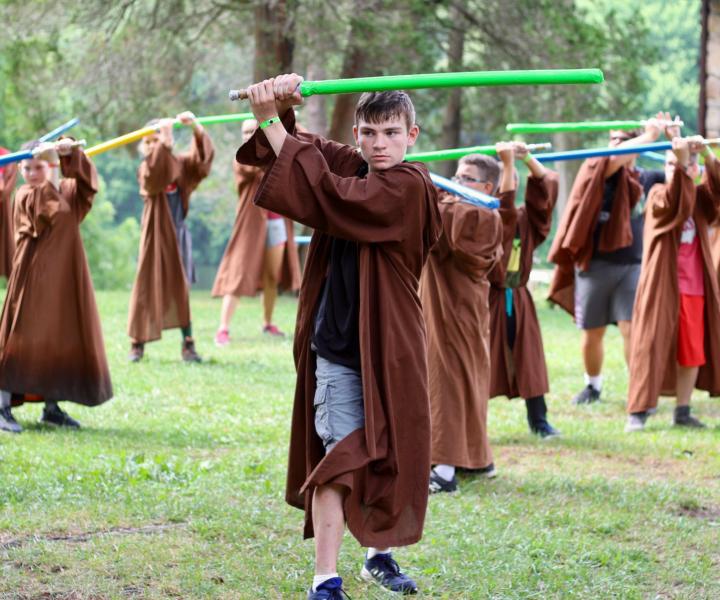 Boy camper with light saber